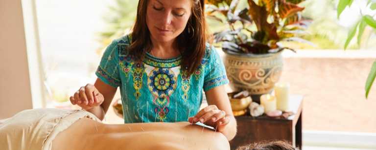 Female acupuncturist working on client