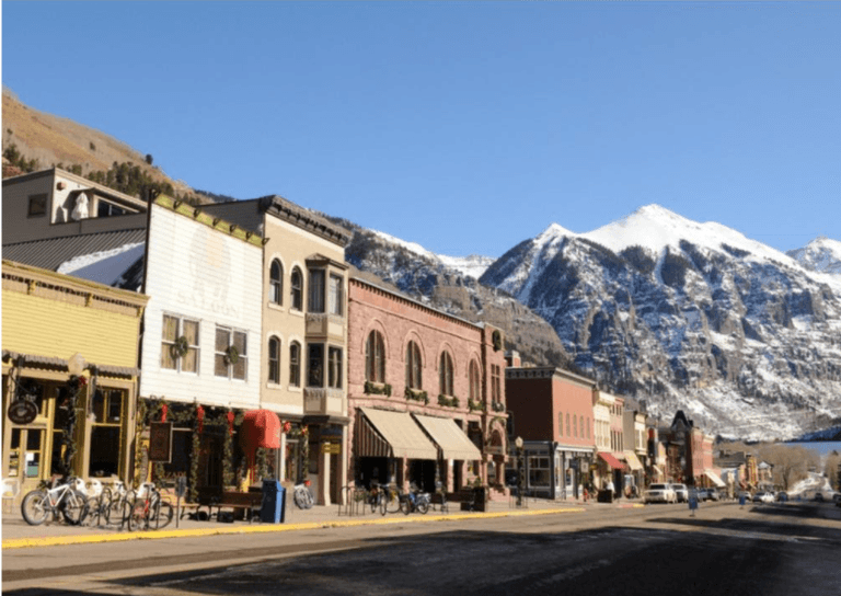 view of a small town main street with mountains in background in Colorado