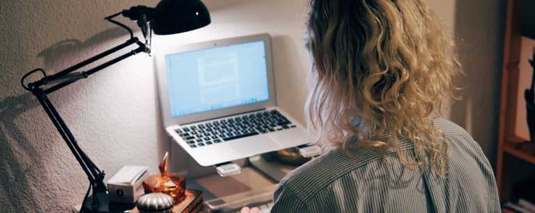 Freelancer works at laptop in home office