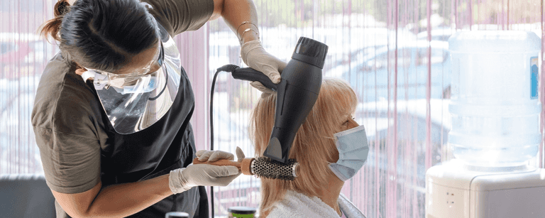 Hair stylist works on client's hair