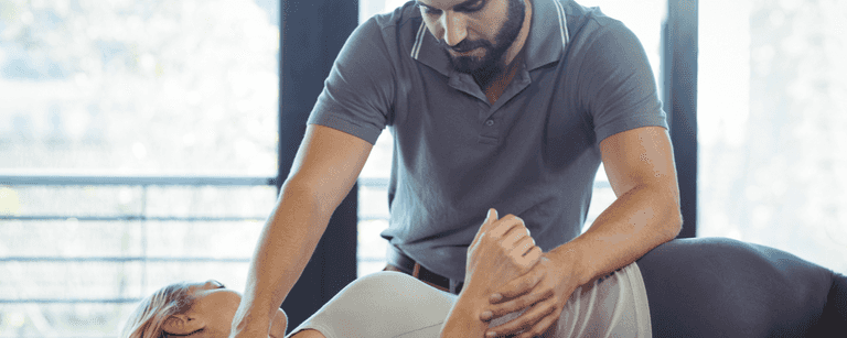 Physical therapist works with client