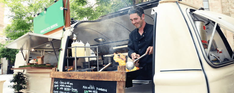 Man happily cooking in his food truck