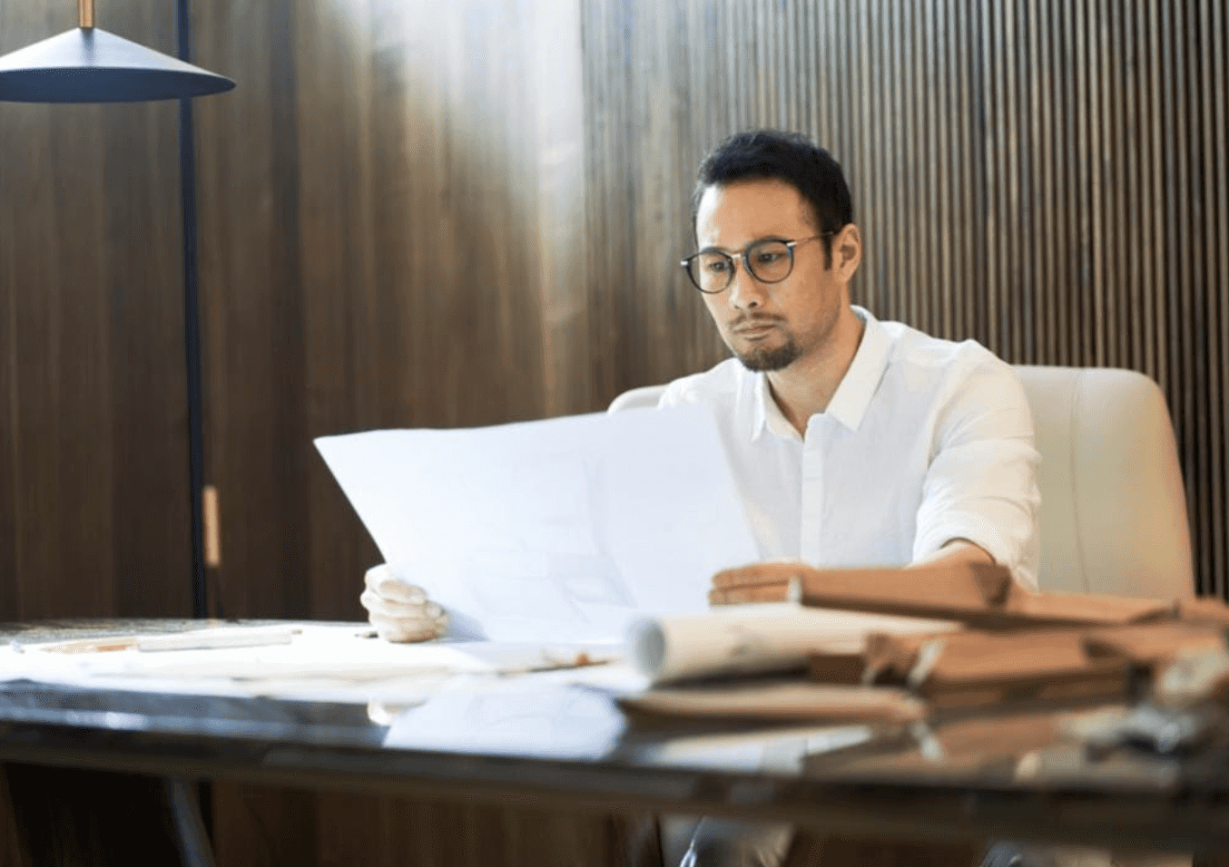 man at desk looking at papers