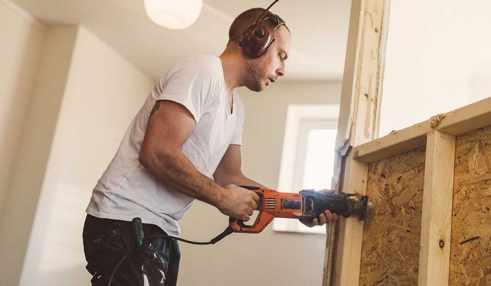 Man using drill tool on plywood