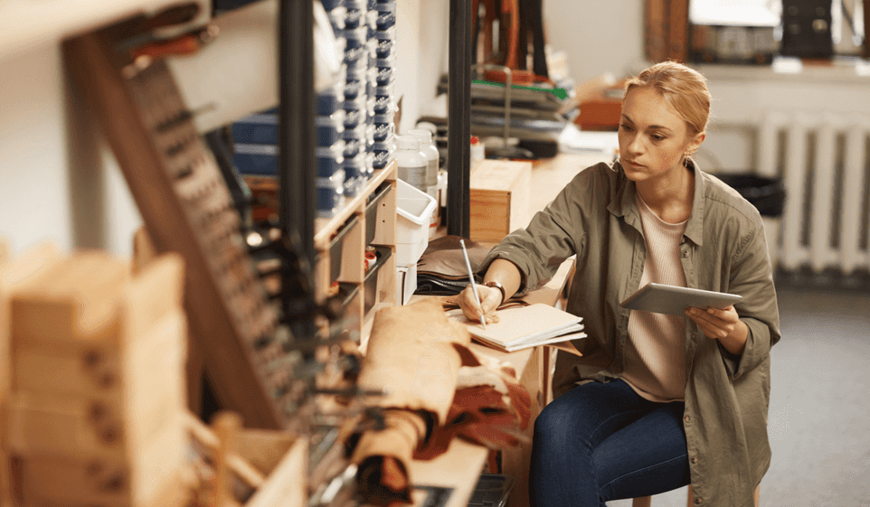 A carpenter reviews her records before buying business insurance.