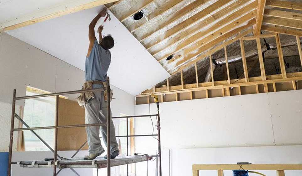 Man with Delaware contractor license works on rebuilding a ceiling
