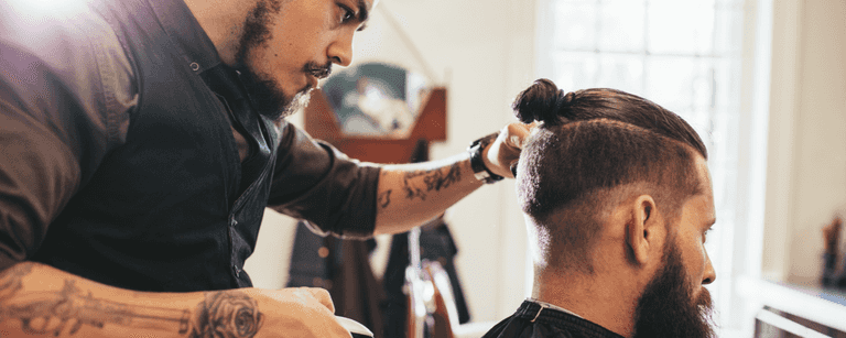 Barber cuts client's hair
