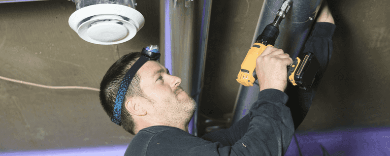 HVAC technician installs vents
