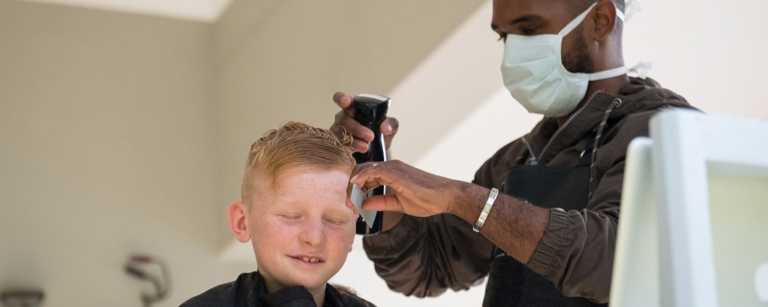 Mobile hairdresser cuts child's hair