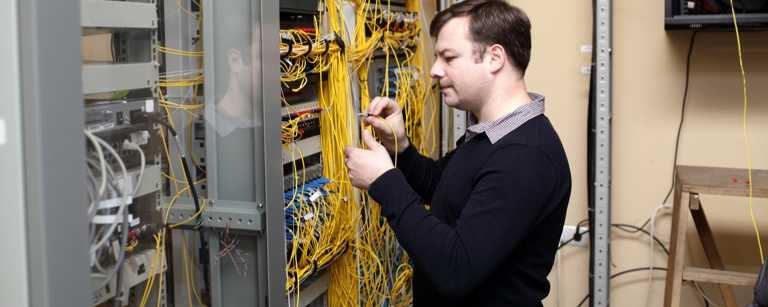 IT contractor checking server cables