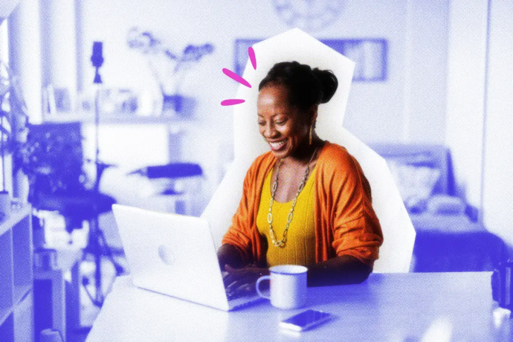 Smiling ecommerce business owner working with laptop