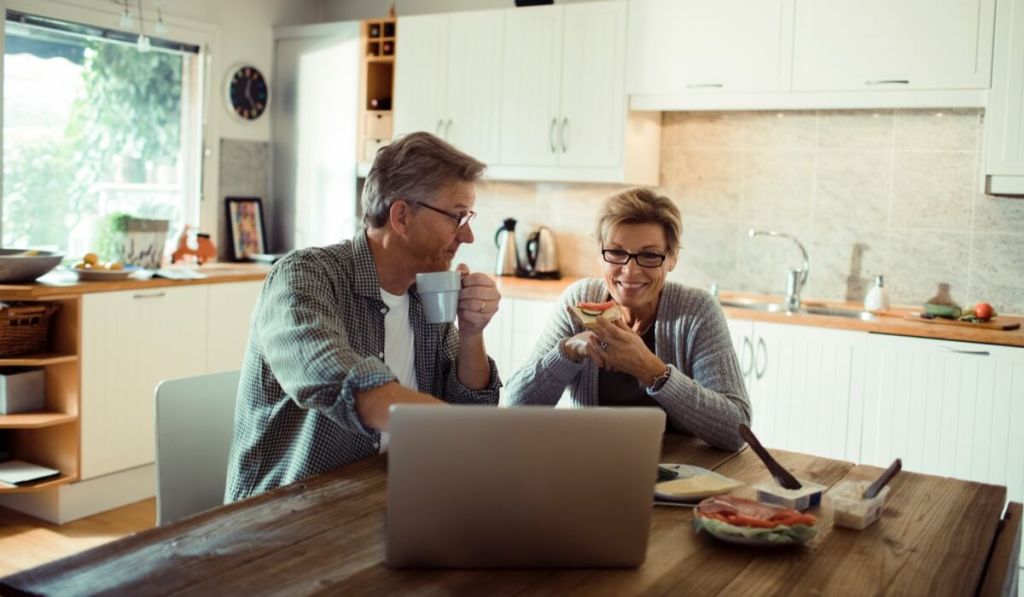 Two entrepreneurs look over small business website designs on their computer.
