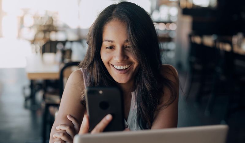 Our guide to digital marketing can be done right on your phone, like this small business owner is doing.