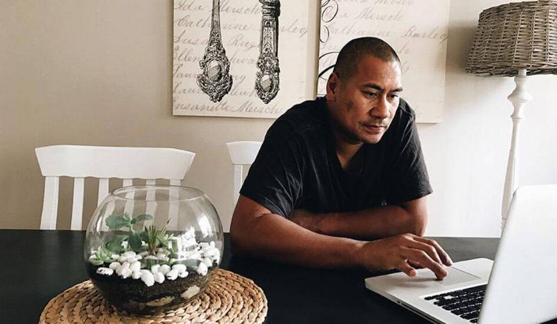 A man is sitting at his laptop learning if he needs cleaning business insurance