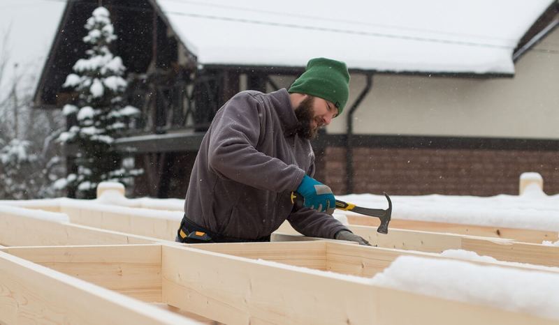Getting a contractor’s license in Colorado lets you work on larger projects, like this contractor working on framing a house.