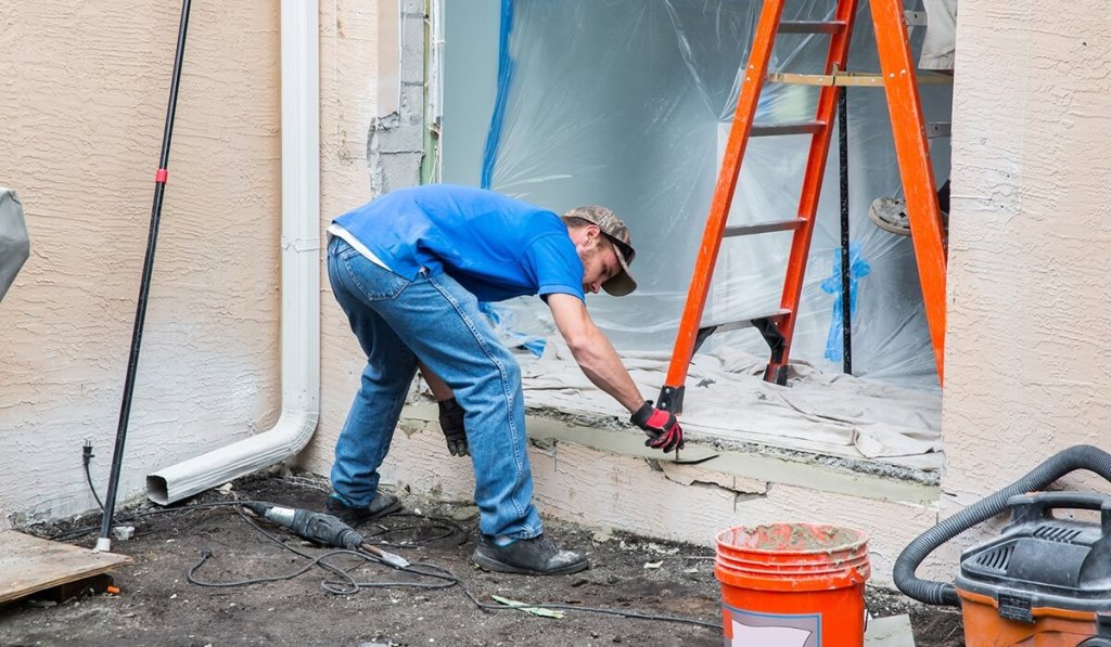 A Washington contractor working on the outside frame of a house