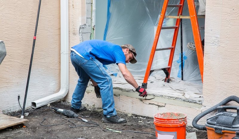 A Washington contractor working on the outside frame of a house
