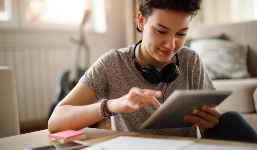 An entrepreneur looks at her small business website on her tablet.