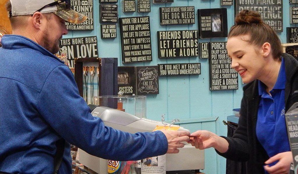 Small Business Saturday can boost your sales, so make sure you're as prepared as this business owner working the cash register.