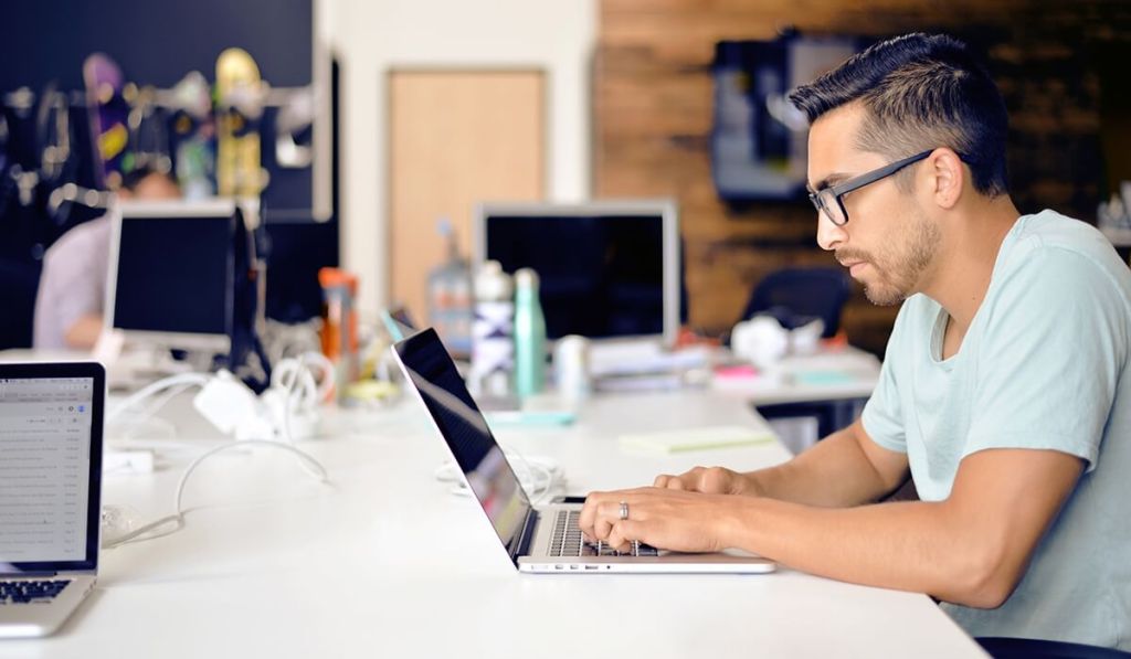 Facebook insights can help you market your small business better, like this entrepreneur at his computer.