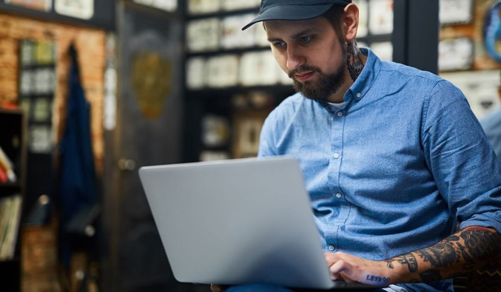 Take time to plan out your small business taxes, like this business owner working at his laptop.