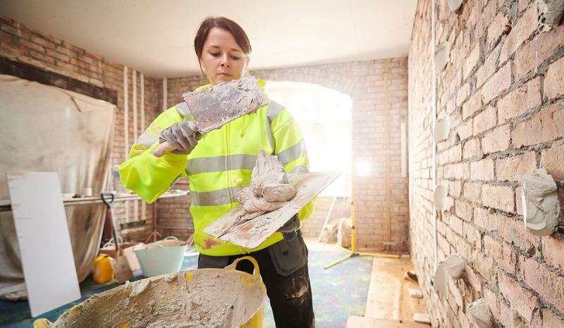 Getting an Illinois contractor license lets you work on larger projects, like this contractor mixing cement.