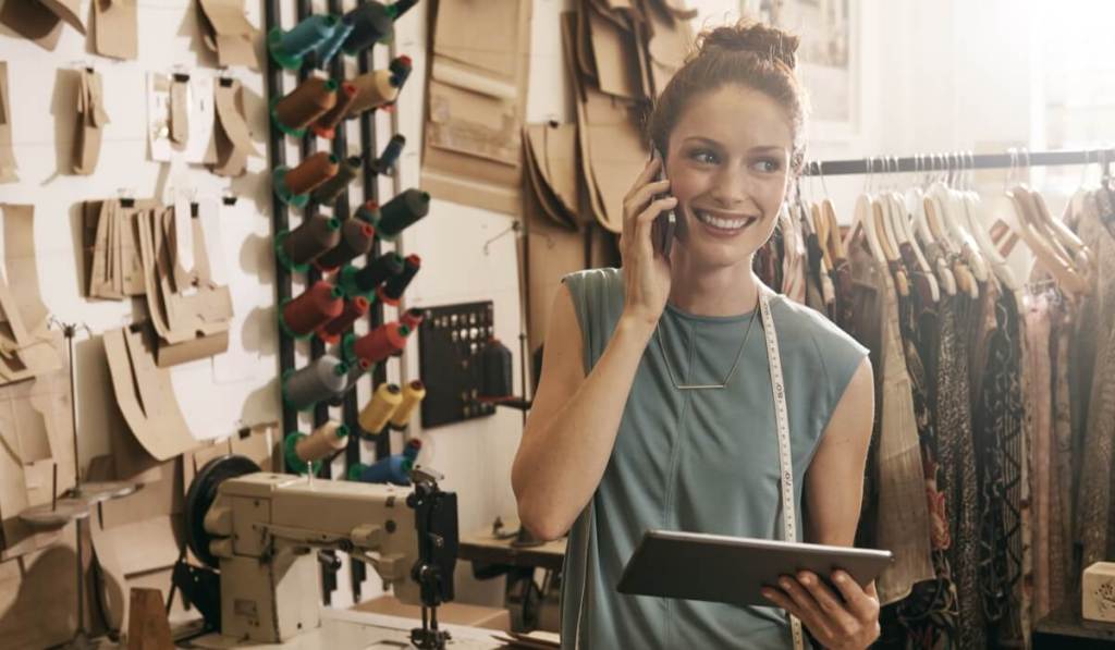 These creative advertising ideas can be used by small business owners, including this entrepreneur on her phone.