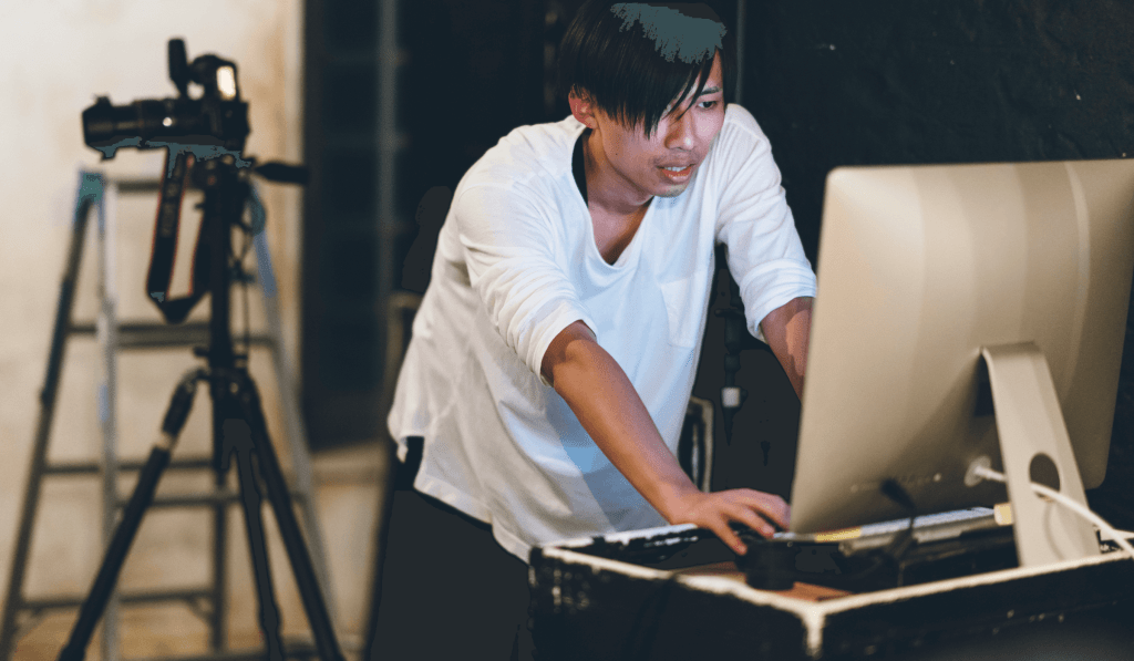 Photographer works on iMac to edit photos.