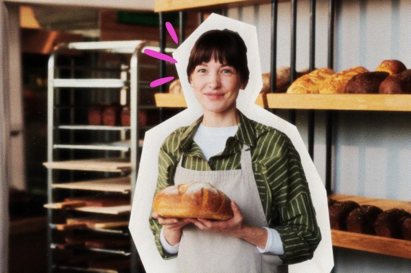 Woman holding loaf of bread and smiling