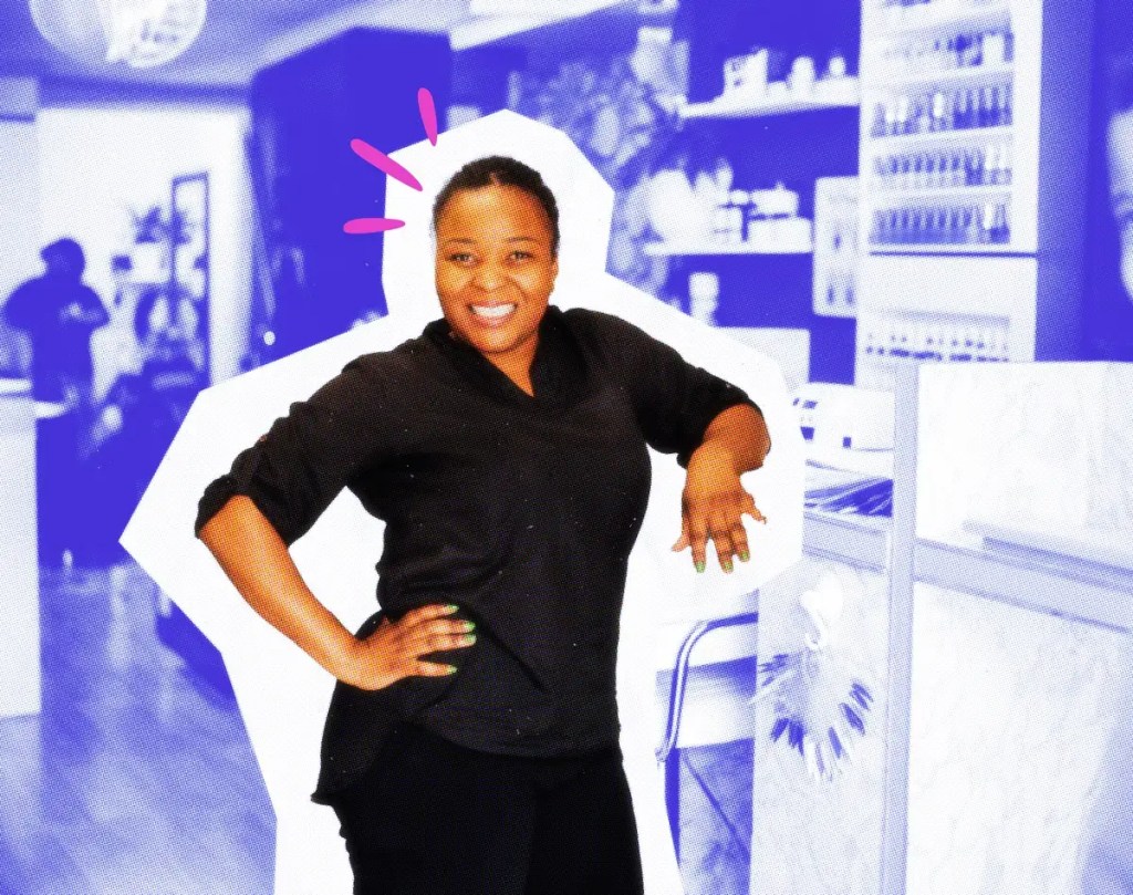 Smiling nail tech in her salon.