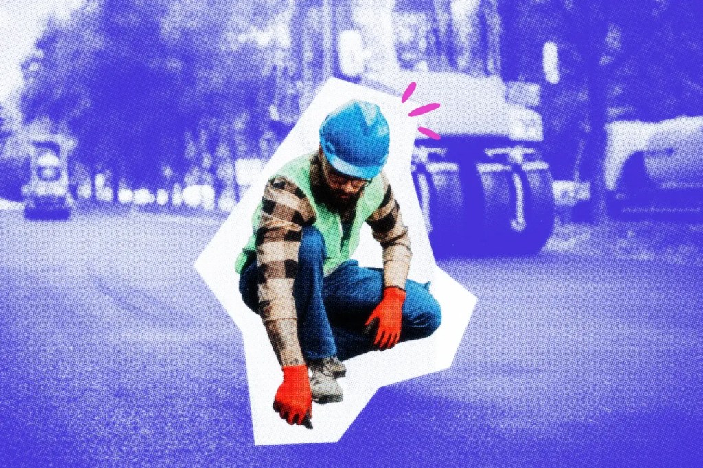 Construction worker inspecting a section of road
