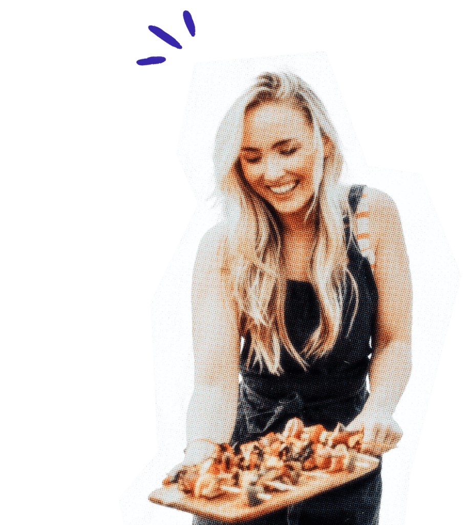 Caterer holding a wooden tray with appetizers.
