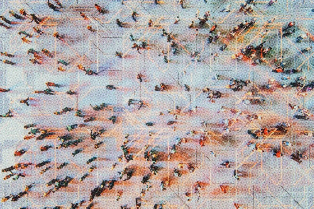 Abstract aerial view of a busy square with many people.