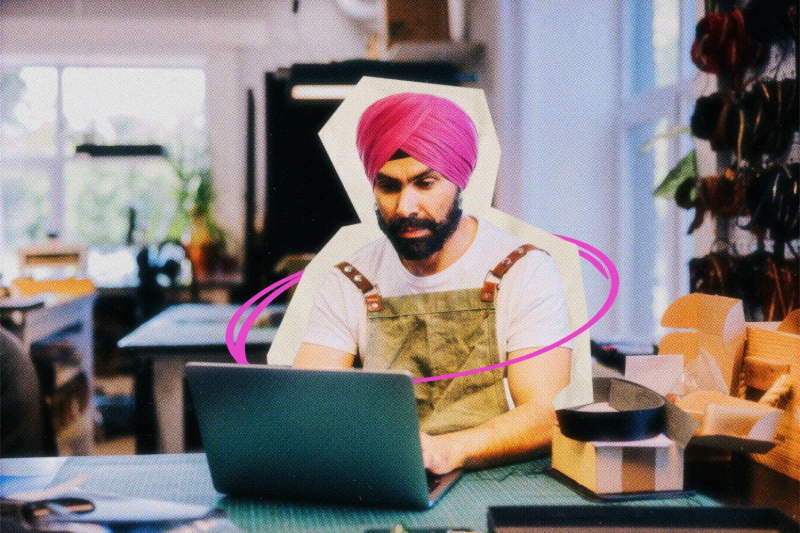 Business owner wearing a turban working on a laptop