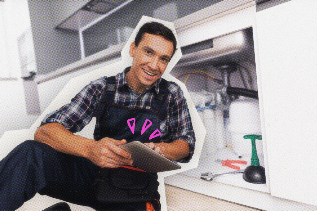A plumber using a tablet device.