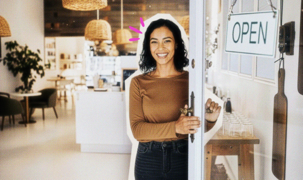 Smiling business owner standing in the doorway of her shop.