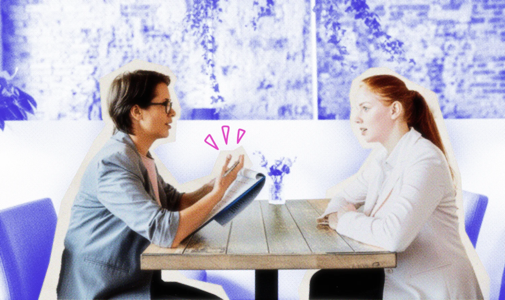 Small business owner interviewing a potential employee at a table