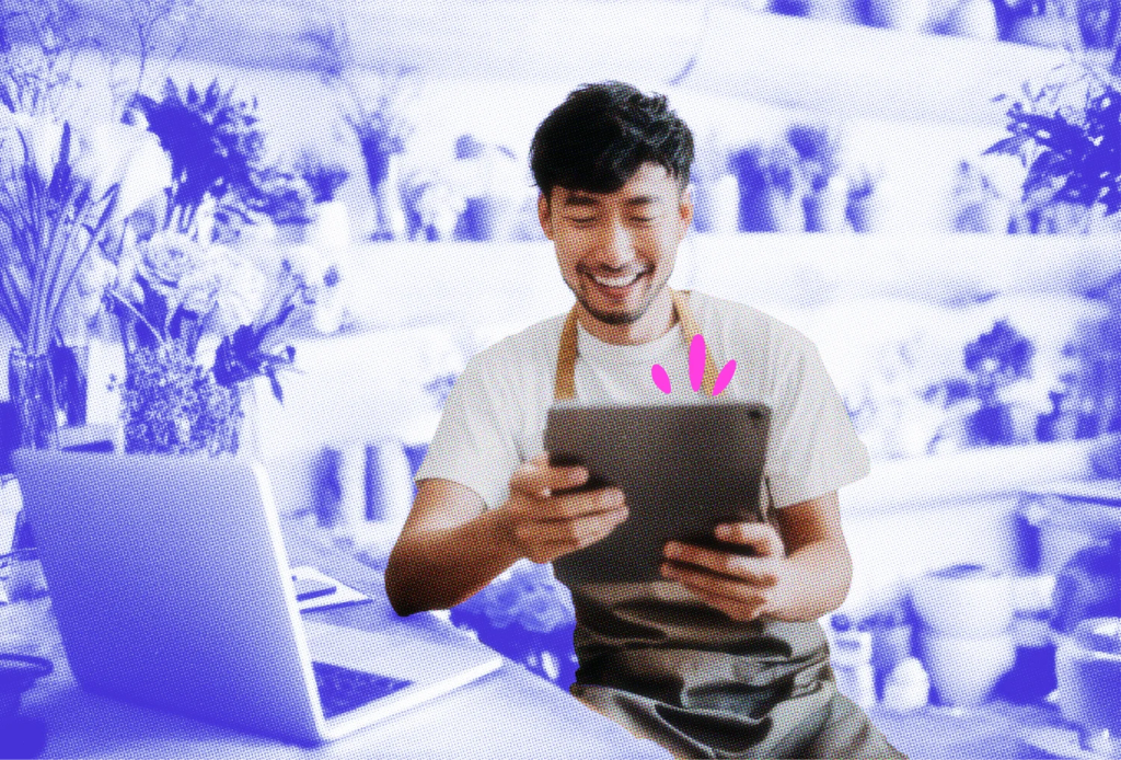 Florist shop owner checking an email on his tablet