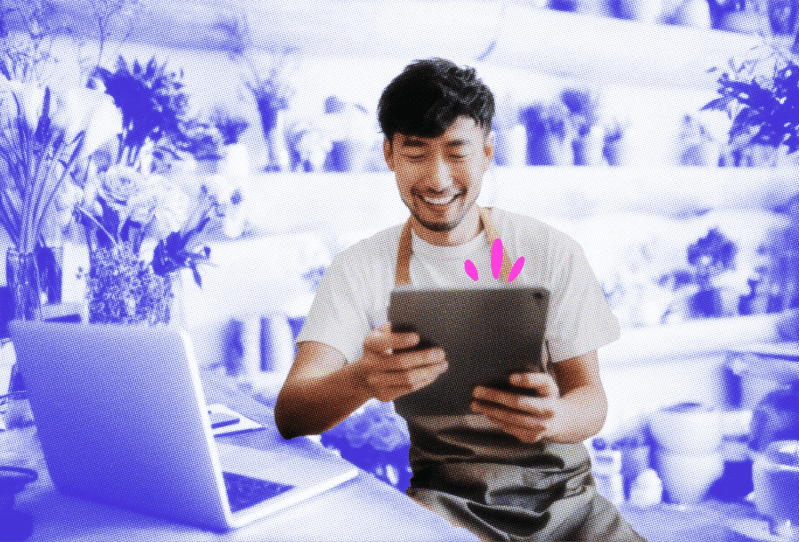 Florist shop owner checking an email on his tablet