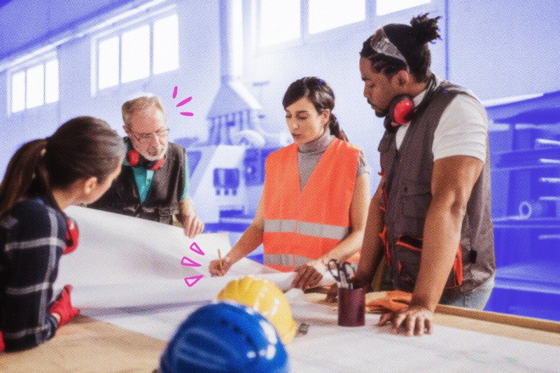 A group of carpenters reviewing blueprints on a table.
