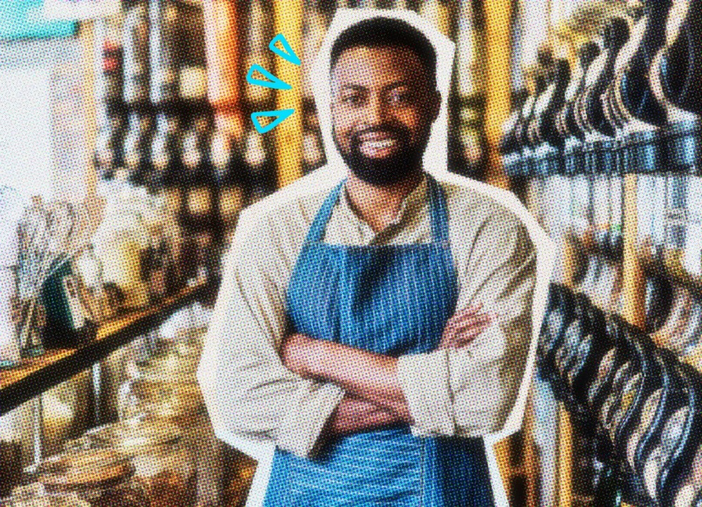 Smiling business owner behind the counter of his shop.
