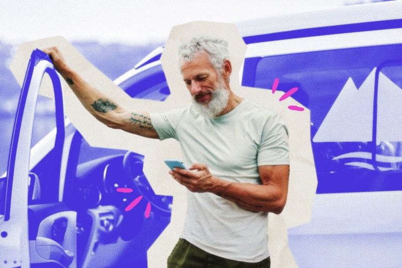 Business owner getting out of a vehicle and looking at his phone.