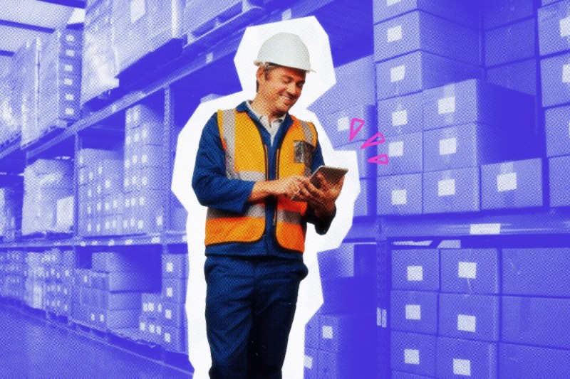 Business owner in a warehouse with a handheld device