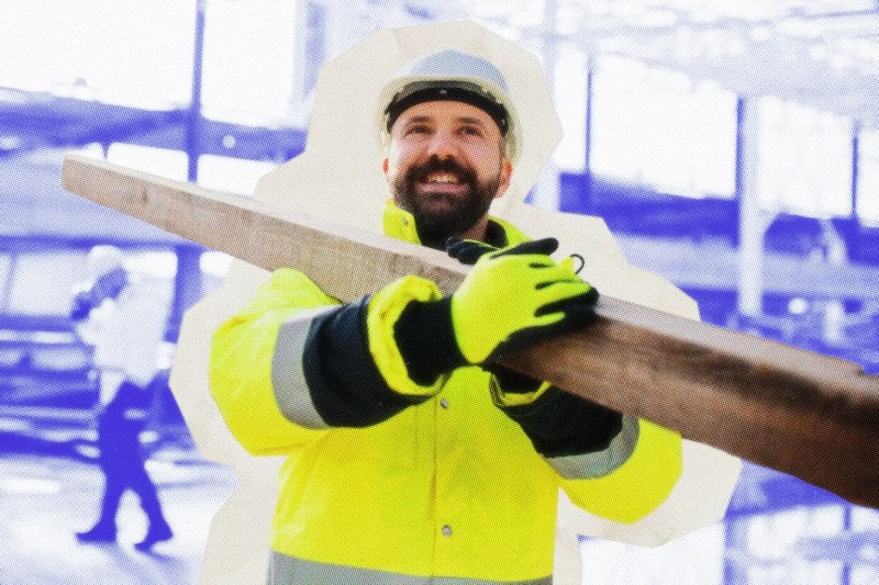 Contractor carrying a 4x4 post