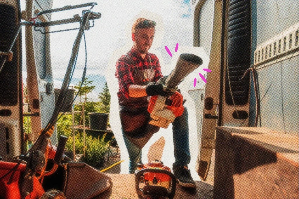 Man removing a leaf blower from the back of a van