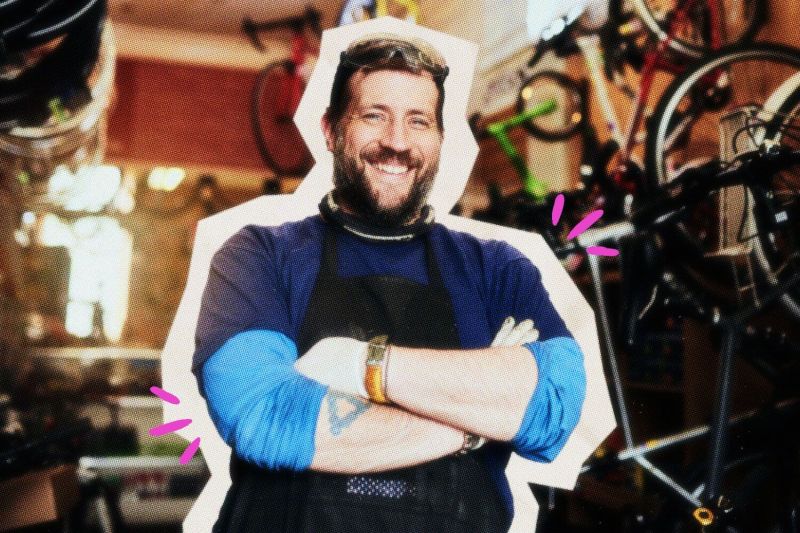 Proud solopreneur standing in front of his work.